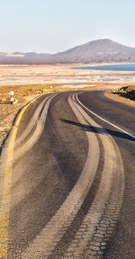 Scenic view of road by land against sky