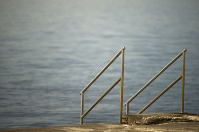 Close-up of railing against sea