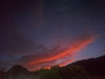 Low angle view of rainbow against sky at sunset