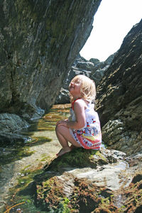 Full length of woman on rock by mountains