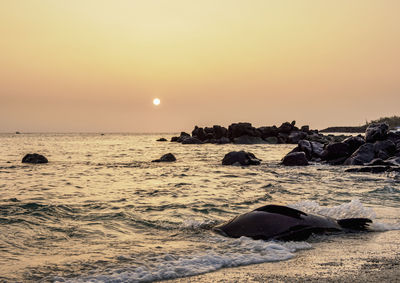 Scenic view of sea against sky during sunset