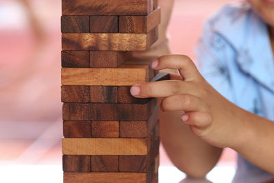 Midsection of man holding wooden blocks