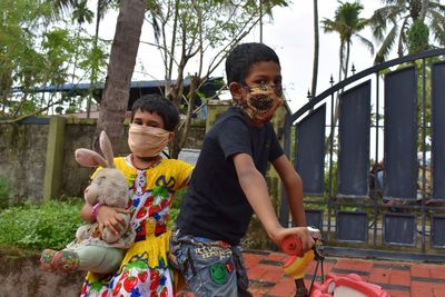 A boy and girl wear mask to protect from coronavirus.