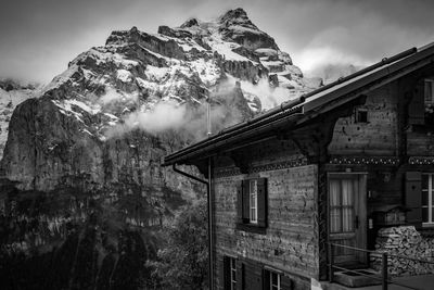 Low angle view of building and mountains against sky