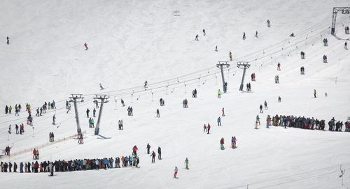 High angle view of people on snow covered landscape