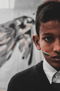 Portrait of boy with painted cheek