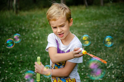 Boy playing with bubbles