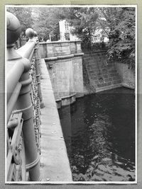 Close-up of hand holding rope in river