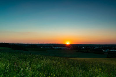 Scenic view of field against sky during sunset