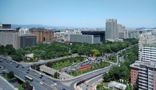 High angle view of street amidst buildings against sky