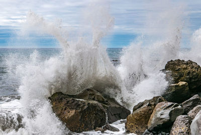 Waves splashing on rocks at shore