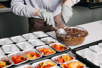 Midsection of man preparing food