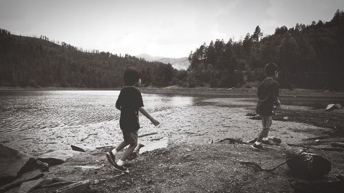 Rear view of boys playing in water