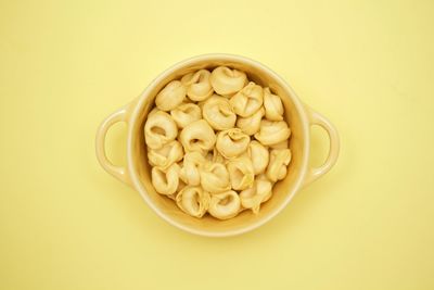 Directly above shot of pasta in bowl against white background