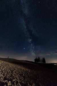 Scenic view of field against milky way and sky at night