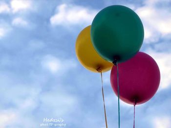 Close-up of multi colored balloons against sky