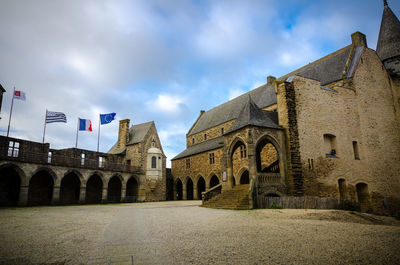 View of old building against cloudy sky