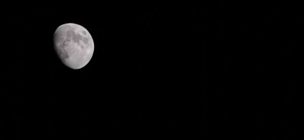 Low angle view of moon against sky at night