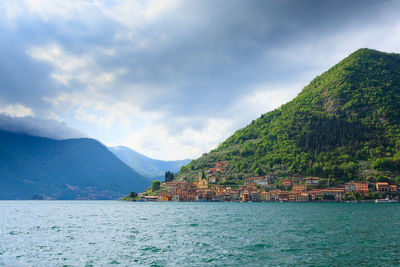 Scenic view of sea and mountains against sky