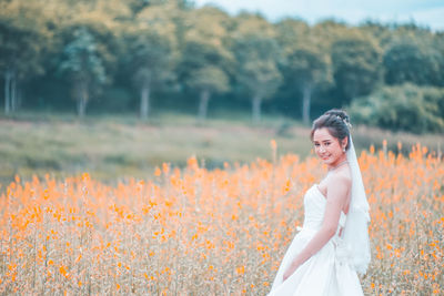 Portrait of woman standing on field