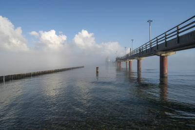 Pier over sea against sky