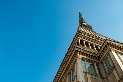 Low angle view of ornate building against clear blue sky