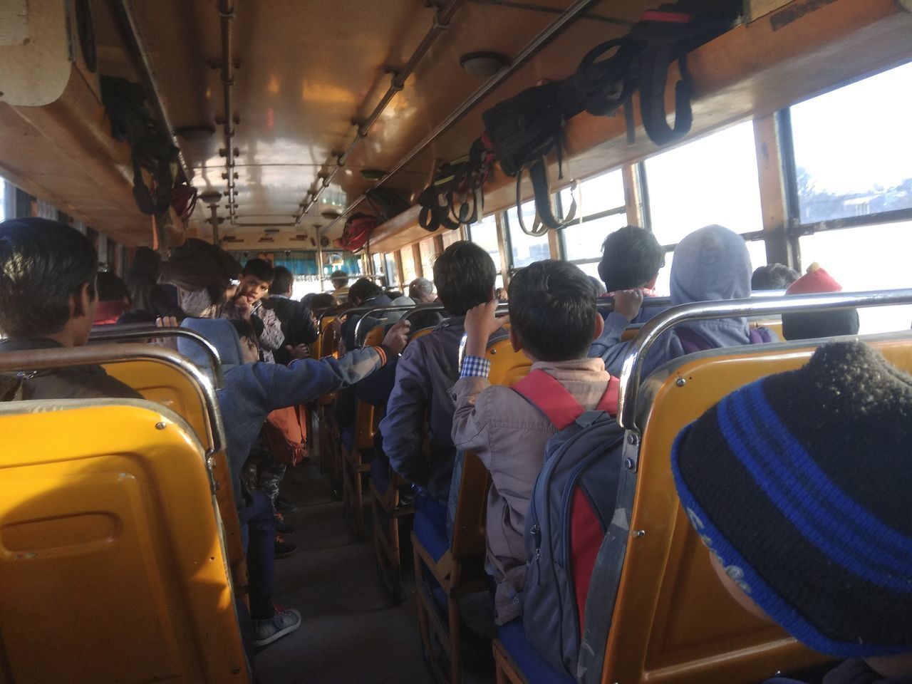 REAR VIEW OF PEOPLE WAITING IN BUS