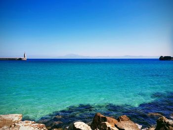 Scenic view of sea against clear blue sky