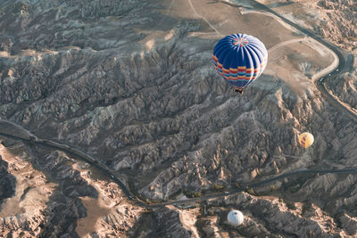 High angle view of hot air balloon flying over water