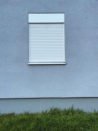 Window on white wall of building