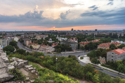 High angle view of buildings in city during sunset