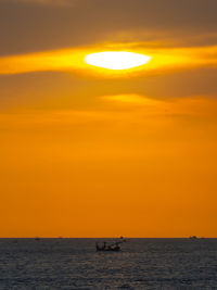 Scenic view of sea against orange sky