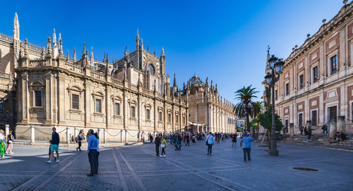 Group of people walking in front of buildings