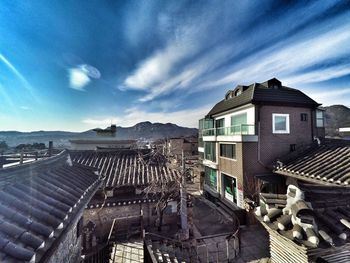 Buildings against cloudy sky