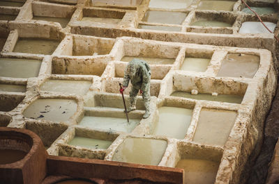 Low angle view of man working on wall