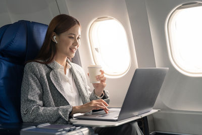 Young woman using laptop at home