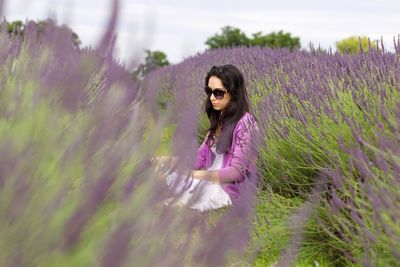 Portrait of woman sitting in lavender field