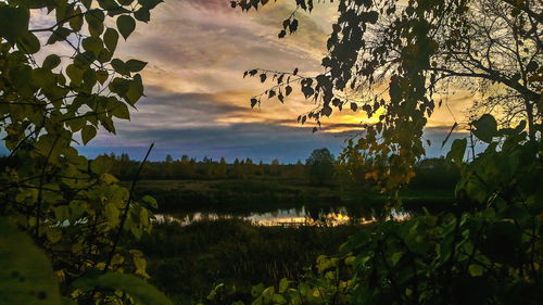 Scenic view of lake against sky at sunset