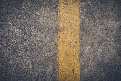 High angle view of yellow road sign on street