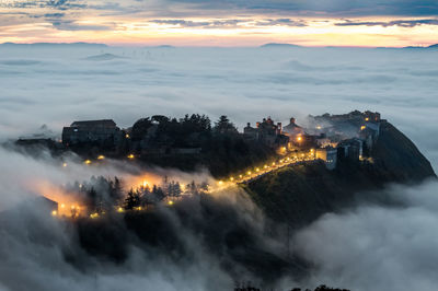 High angle view of illuminated city during sunset