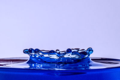 Close-up of blue water against white background