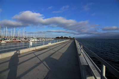 Road by sea against sky