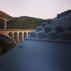 Close-up of bridge over river against sky