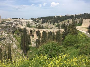 View of arch bridge against cloudy sky