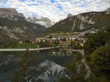 Village by molveno lake at trentino against sky