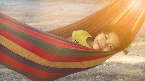 Rear view of girl lying on hammock