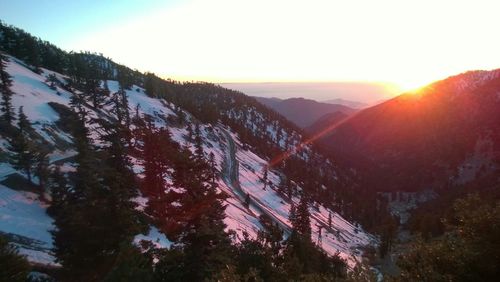 Scenic view of snow covered mountain during sunset