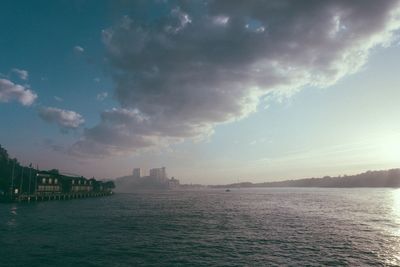 Scenic view of sea by buildings against sky