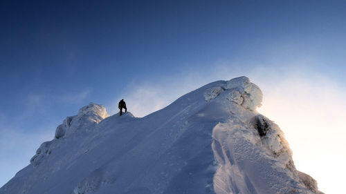 Low angle view of snowcapped mountain against clear sky