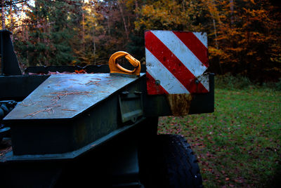 Close-up of empty road amidst plants in forest